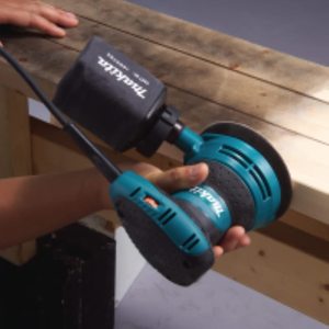 Makita BO5031 Random Orbit Sander in use.