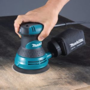 Makita BO5031 Random Orbit Sander in use.