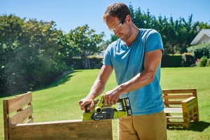 Ryobi R18PL-0 18V ONE+ Cordless Planer in use.