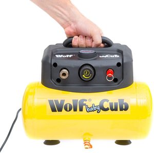 Wolf Baby Cub Portable Air Compressor being carried.